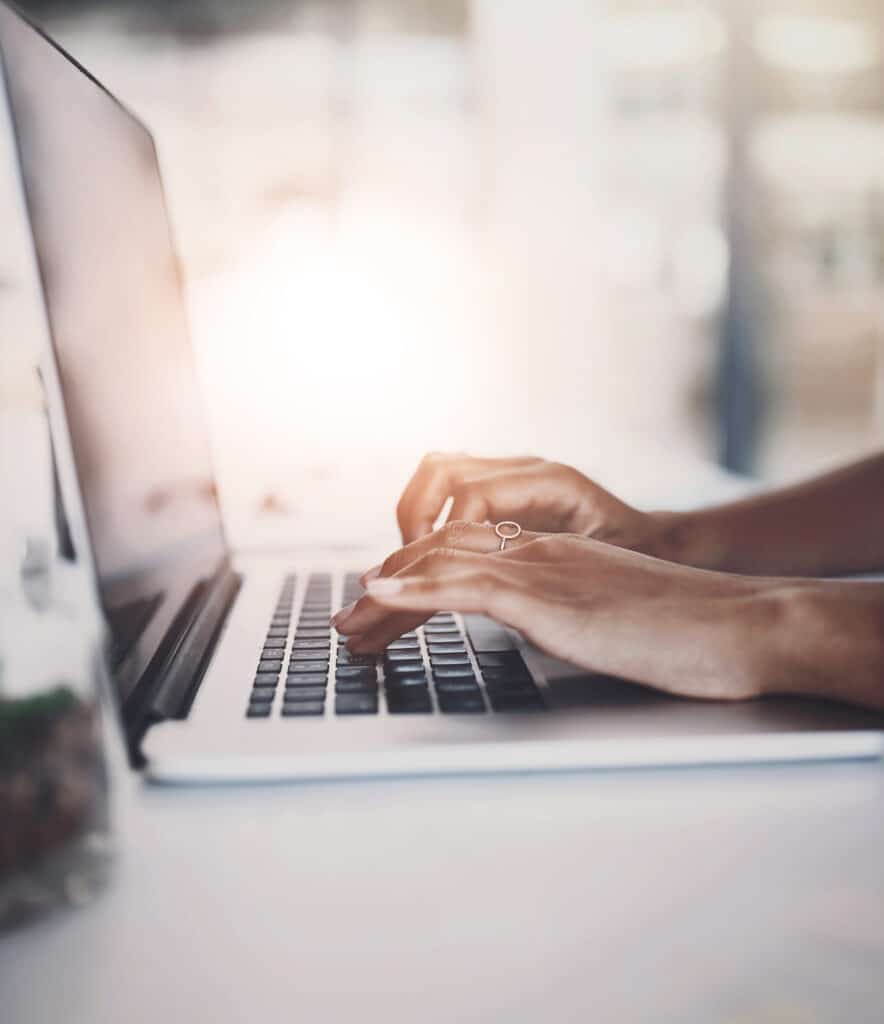 Hands, typing and laptop browsing in office, person and writing email or corporate business on technology. Online, research and planning project for digital information, company website and working